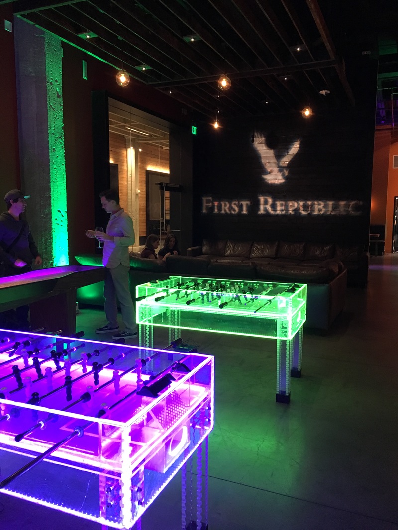 Guests beside illuminated games and First Republic branding at an event